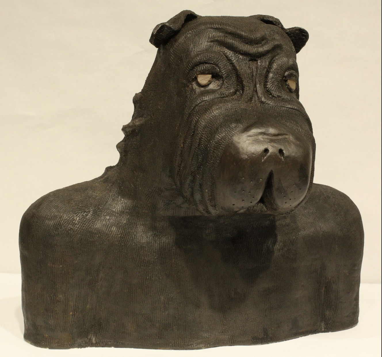 Sculpture of a male bust with a dog head.
