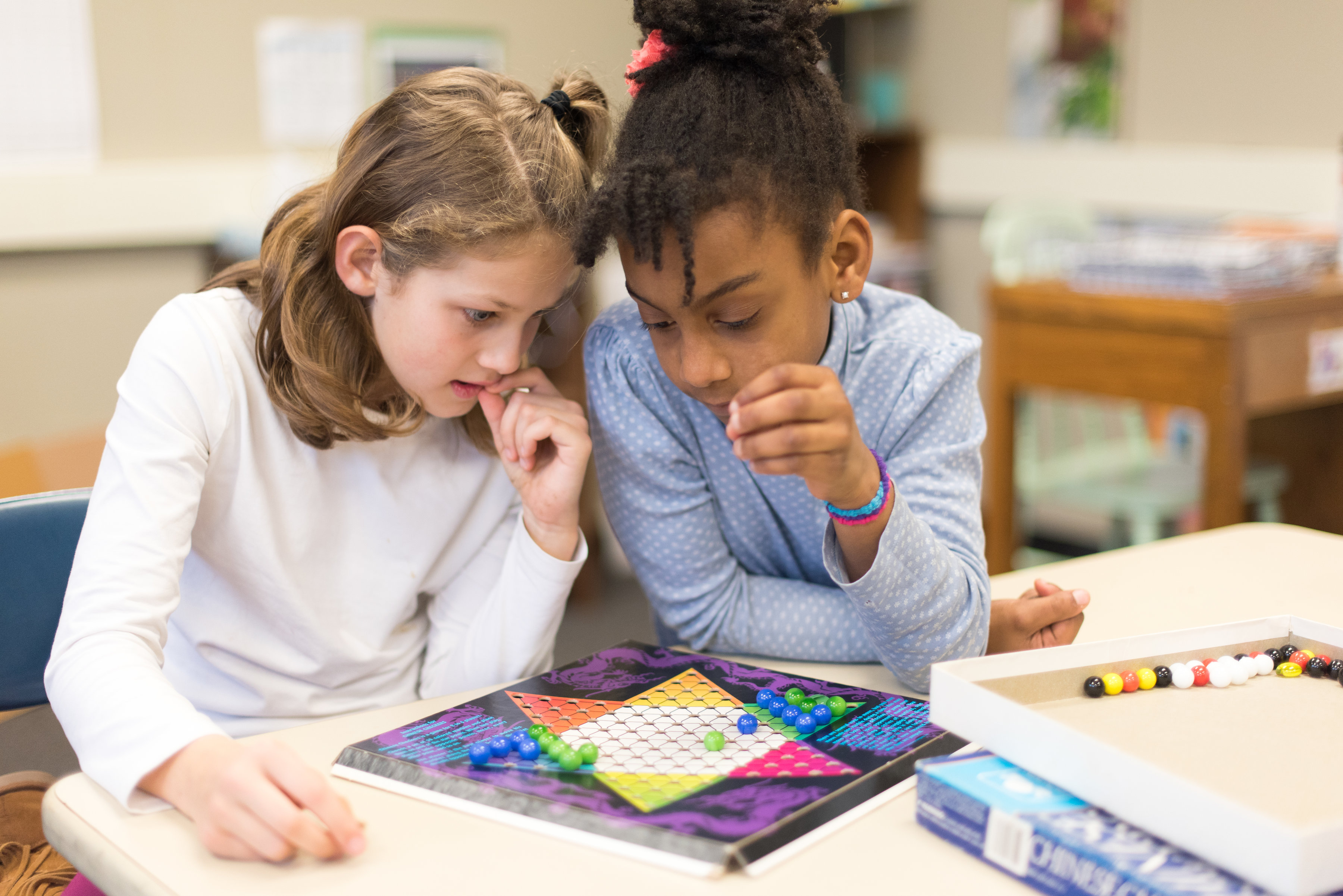 Two children playing a math game at Charlotte Mason School in Detroit courtesy Field-Gems-Photography-Detroit-Michigan-Wedding-Photographer-Family-Photographer